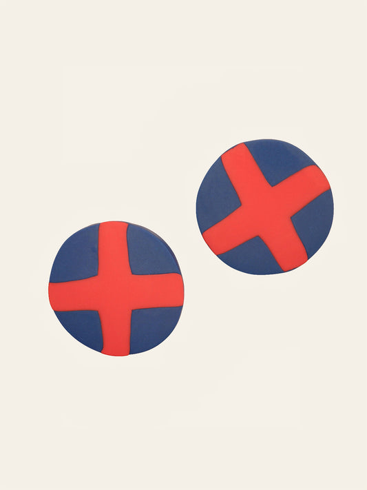 Two round blue stud earrings with red 'X' design on a beige background