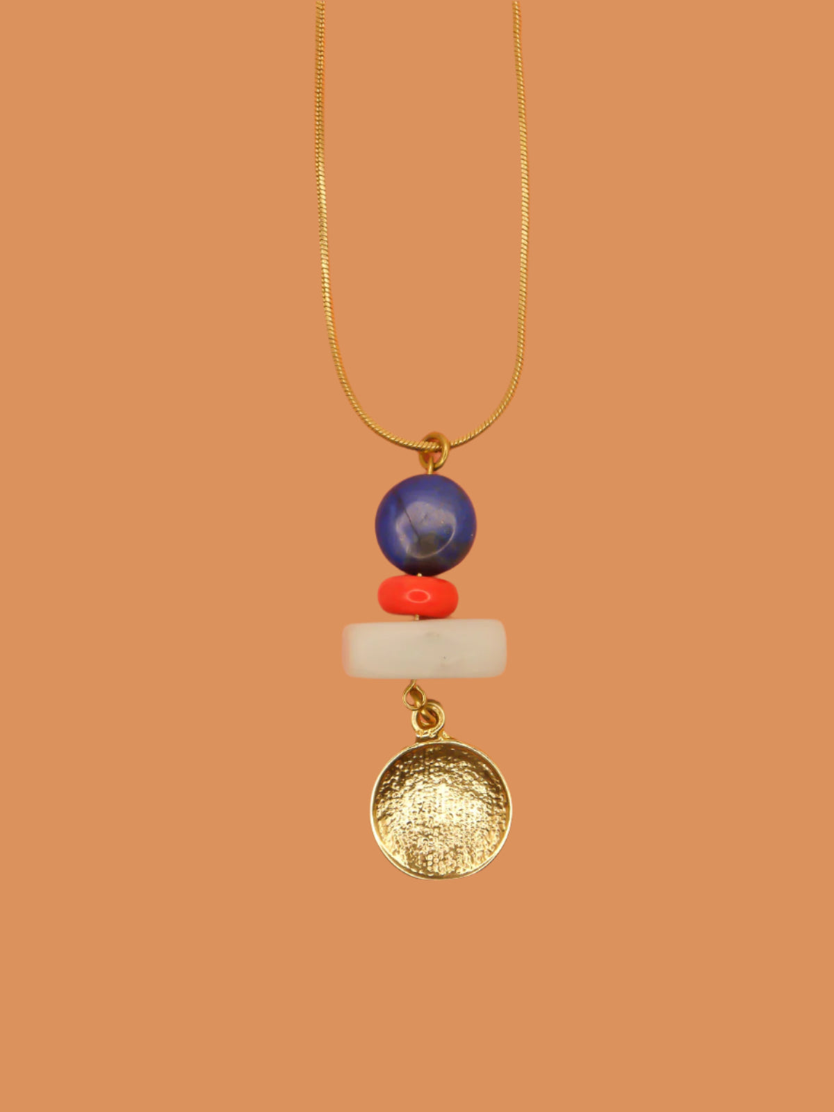 Crystal gemstone pendant necklace with lapis lazuli, coral and amazonite bead stack with a 24k shiny gold hammered disk medallion strung on a 24k gold plated snake chain