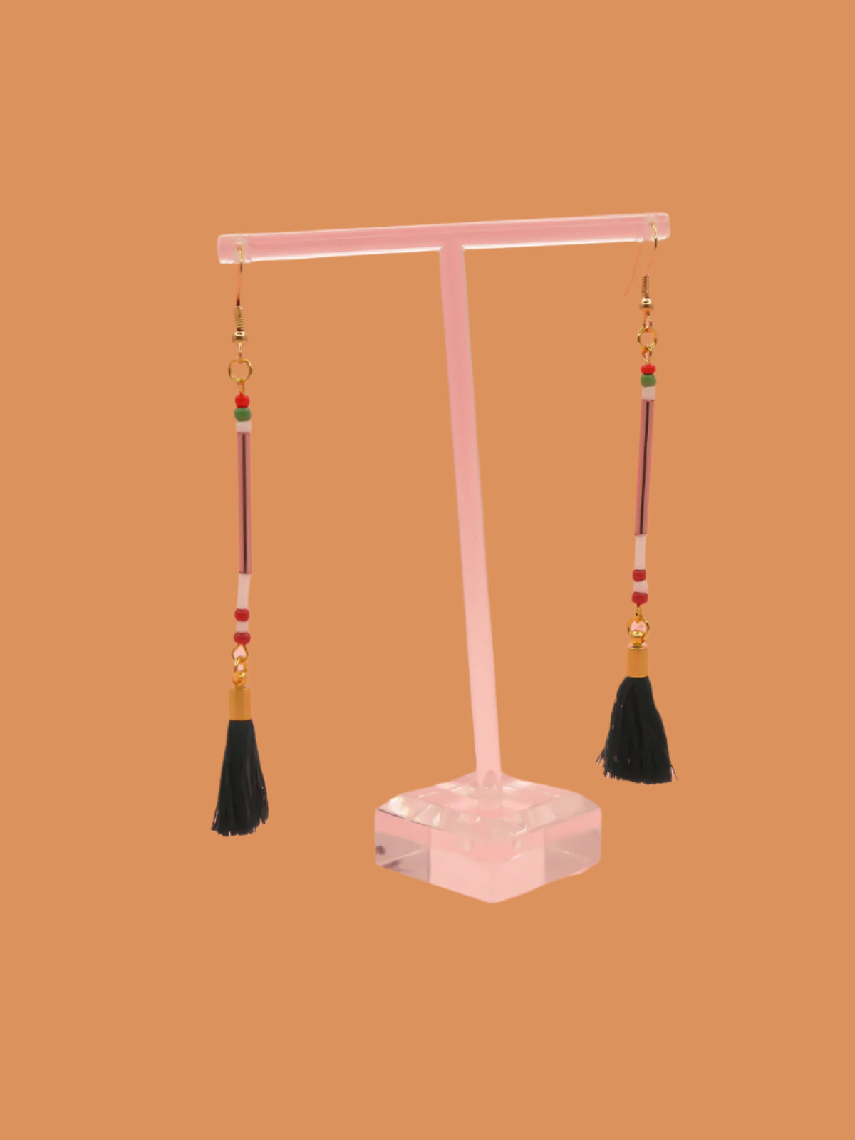 Lightweight long delicate bead stick dangle earrings with lilac glass tube beads & contrasting seed beads in green, white & red, paired with a dark green cotton tassel. Hung from gold plated nickel free ear wires.