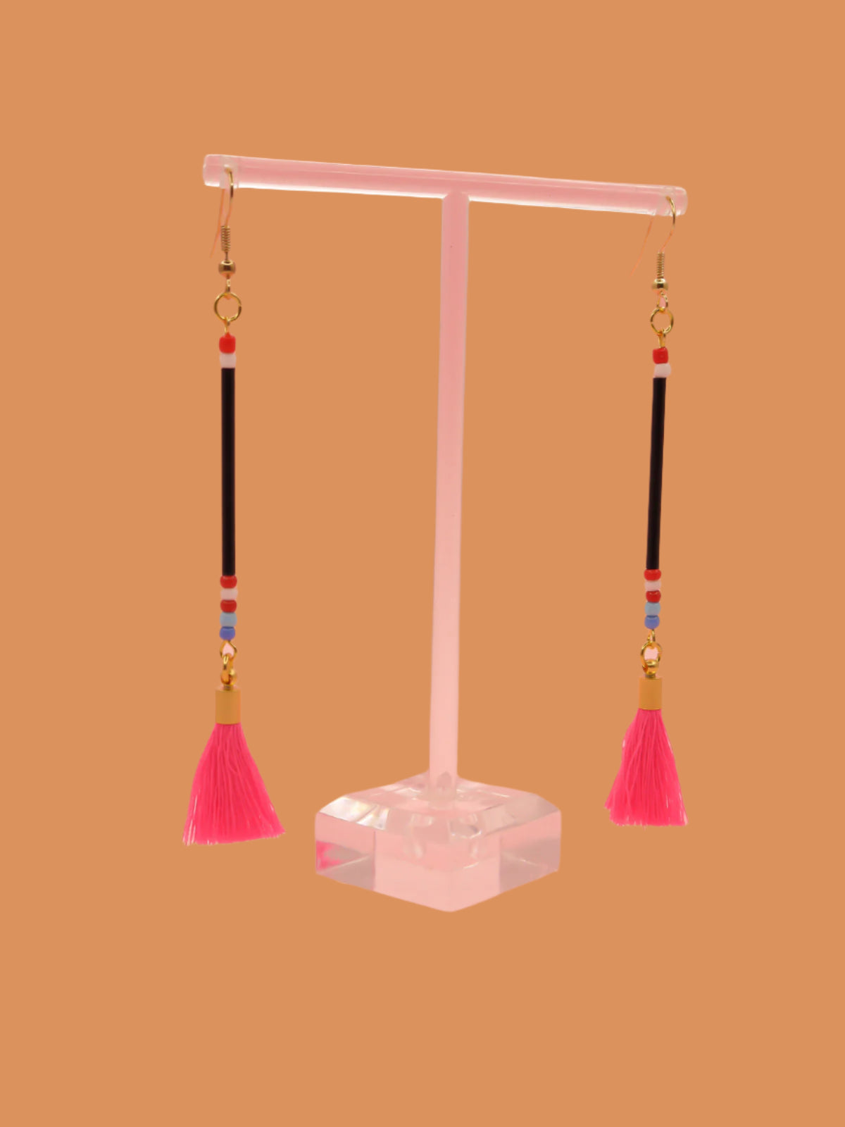 Long delicate bead tassel dangle earrings with black glass beads & multicoloured seed beads with a hot pink cotton tassel hung from gold plated nickel free ear wires