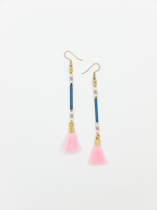 Long beaded tassel earrings with blue glass tube beads and white, pink & grey seed beads with a light pink cotton tassel and hung from gold plated nickel free ear wires