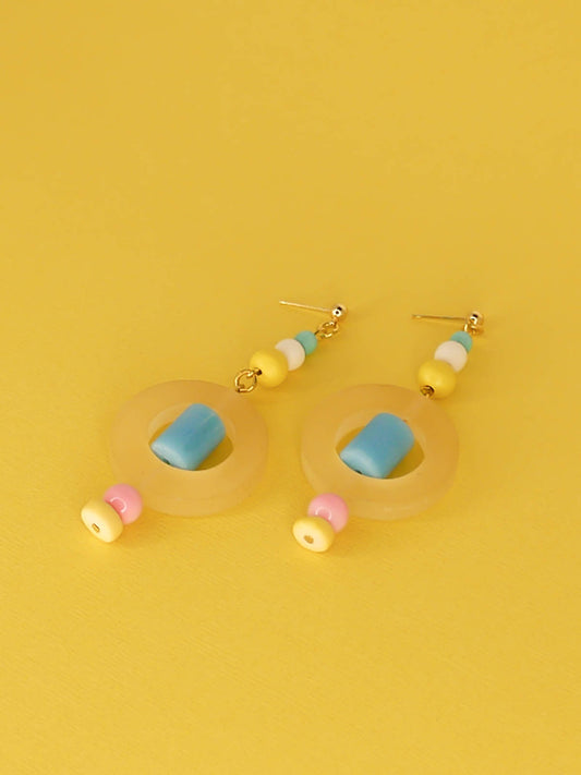 Colourful lightweight hoop bead earrings with glass & wood beads in yellow, pink & turquoise with a resin yellow hoop in the centre & a resin blue tube bead in the middle. Hung from 24k gold plated ball studs.
