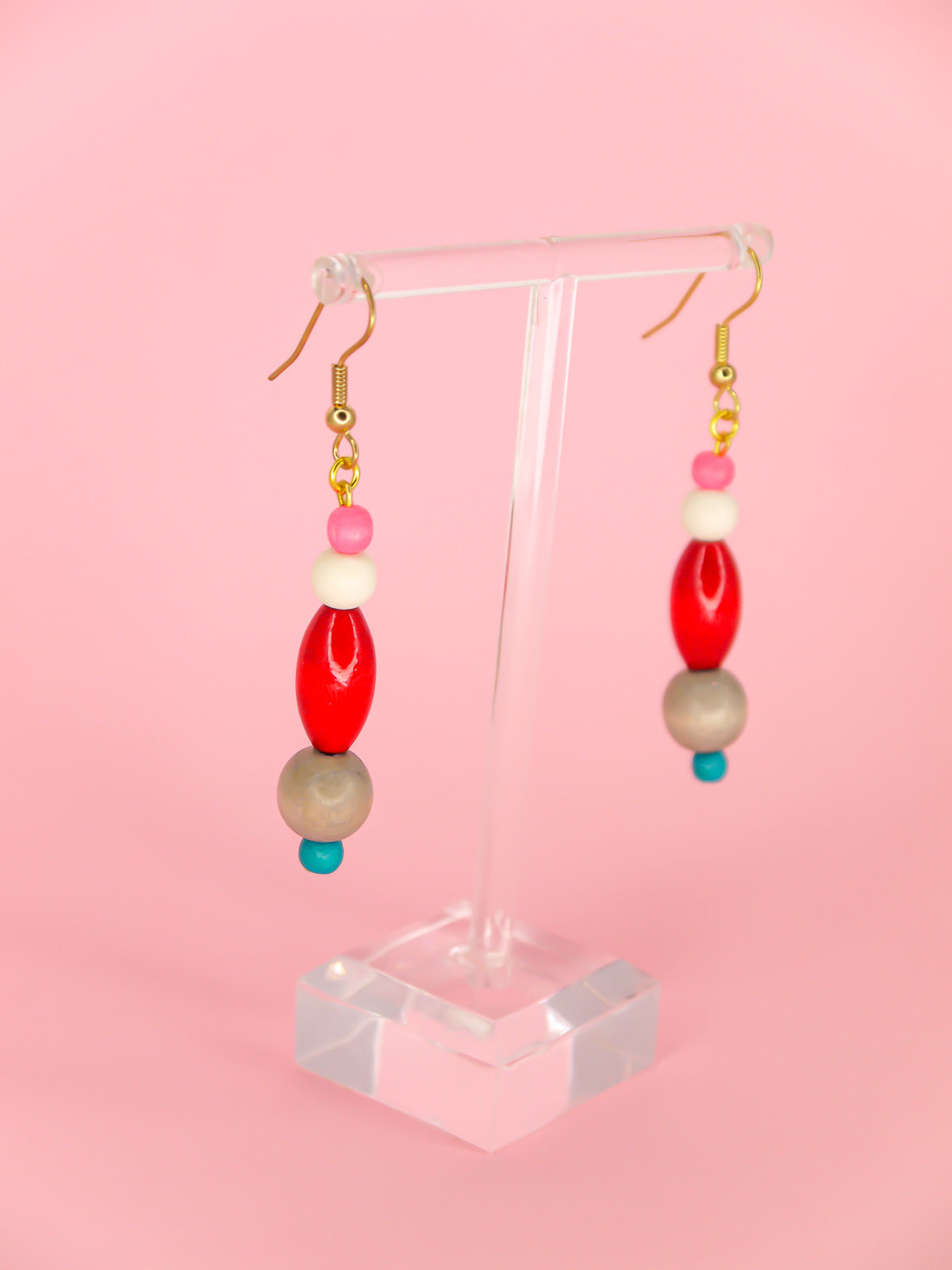 Colourful lightweight wooden bead dangle earrings in various shaped beads in pink, white, red, grey & blue, hung from gold plated ear wires