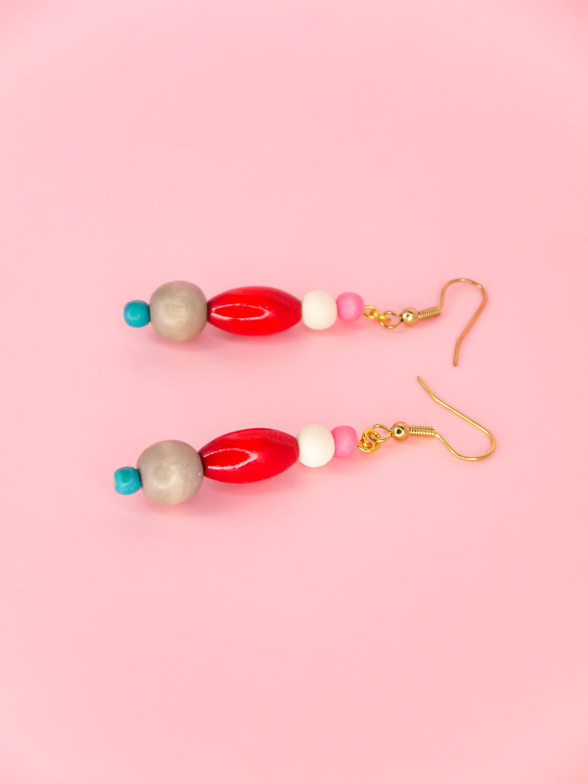 Colourful lightweight wooden bead dangle earrings in various shaped beads in pink, white, red, grey & blue, hung from gold plated ear wires