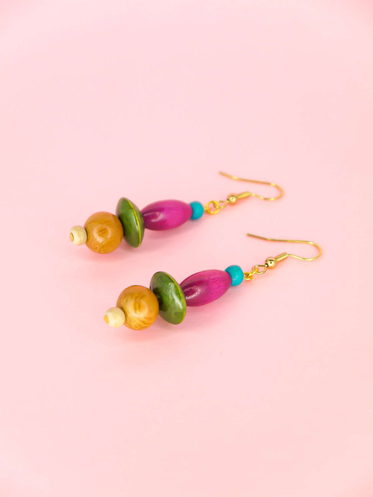 Colourful lightweight wooden bead dangle earrings in various shaped beads in blue, purple, green & browns, hung from gold plated ear wires