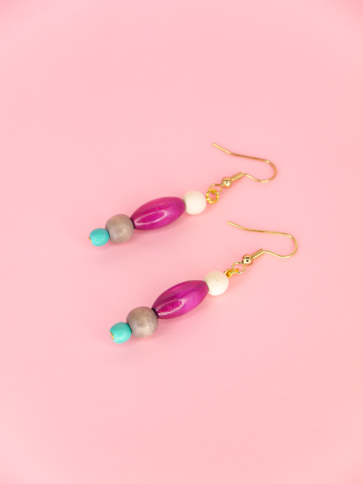 Colourful lightweight beaded dangle earrings in various shaped beads in white, purple, grey & blue, hung from gold plated ear wires