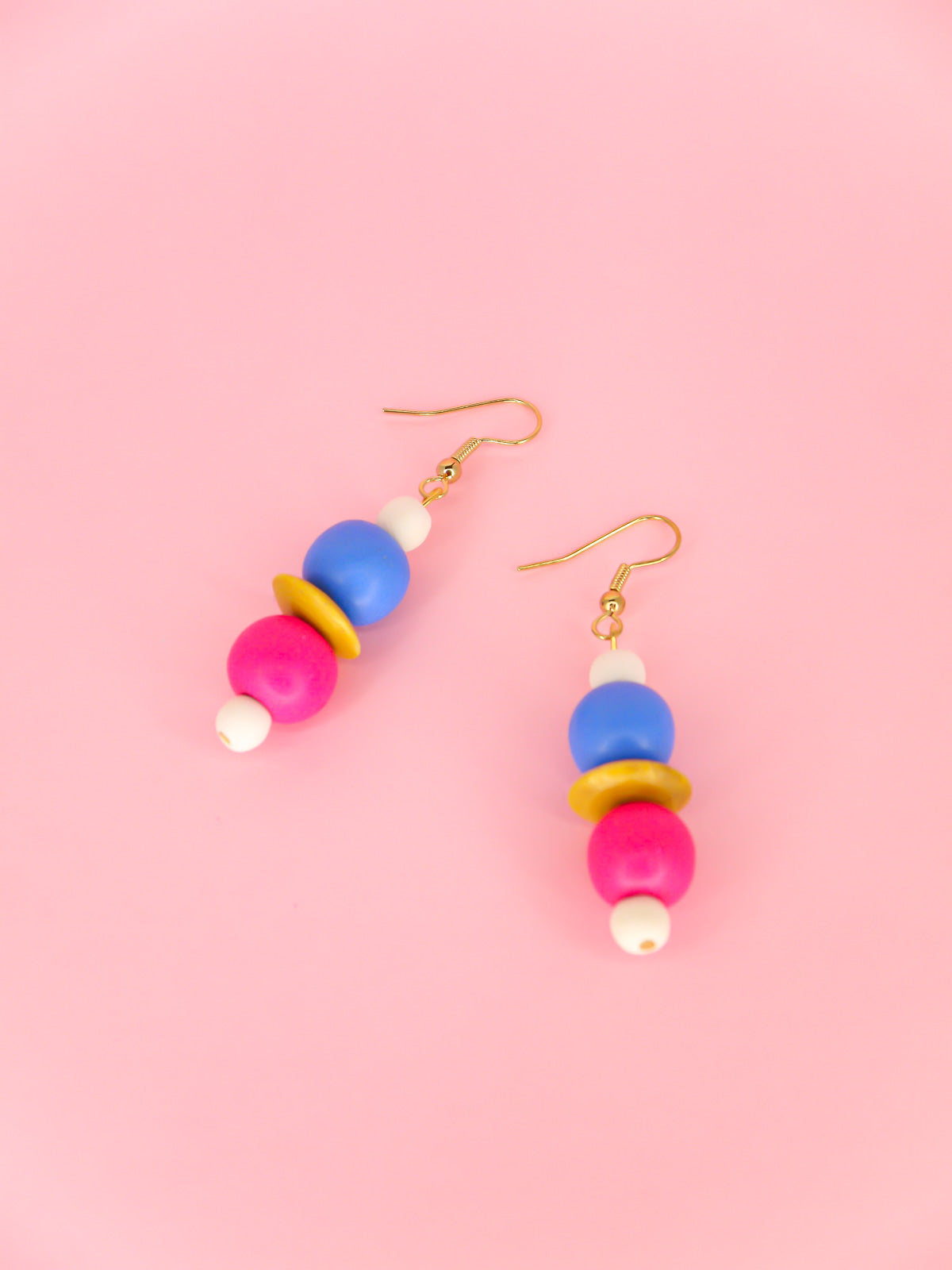 Colourful lightweight wooden bead dangle earrings in white, blue, pink & yellow various sized beads, hung from gold plated ear wires