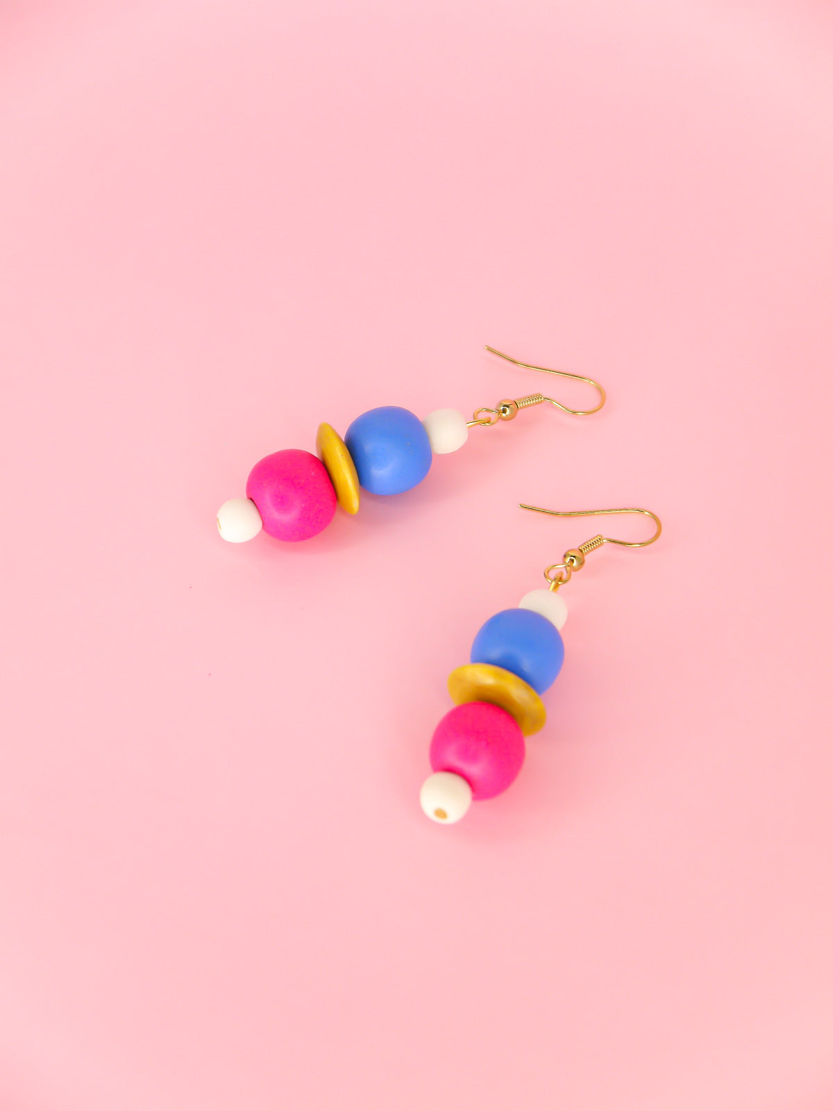 Colourful lightweight wooden bead dangle earrings in white, blue, pink & yellow various sized beads, hung from gold plated ear wires