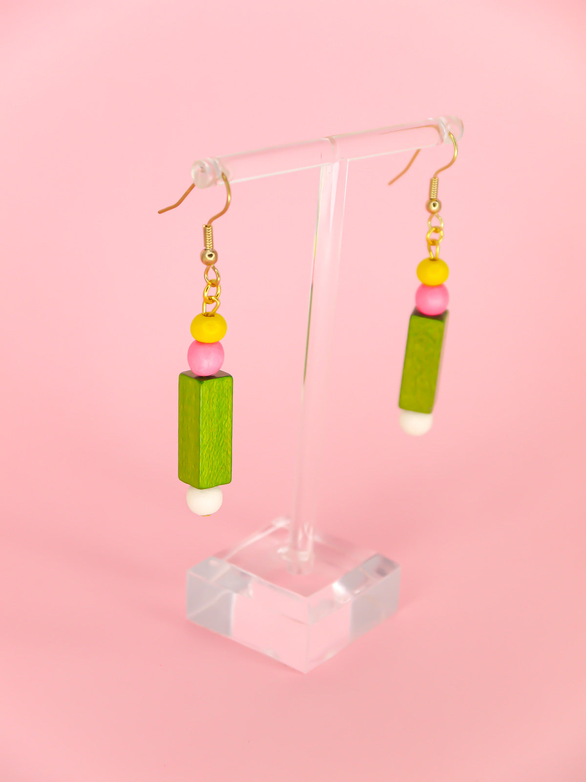 Colourful lightweight wooden bead dangle earrings comprising yellow, pink, green & white beads in various shapes and sizes, hung from gold plated ear wires