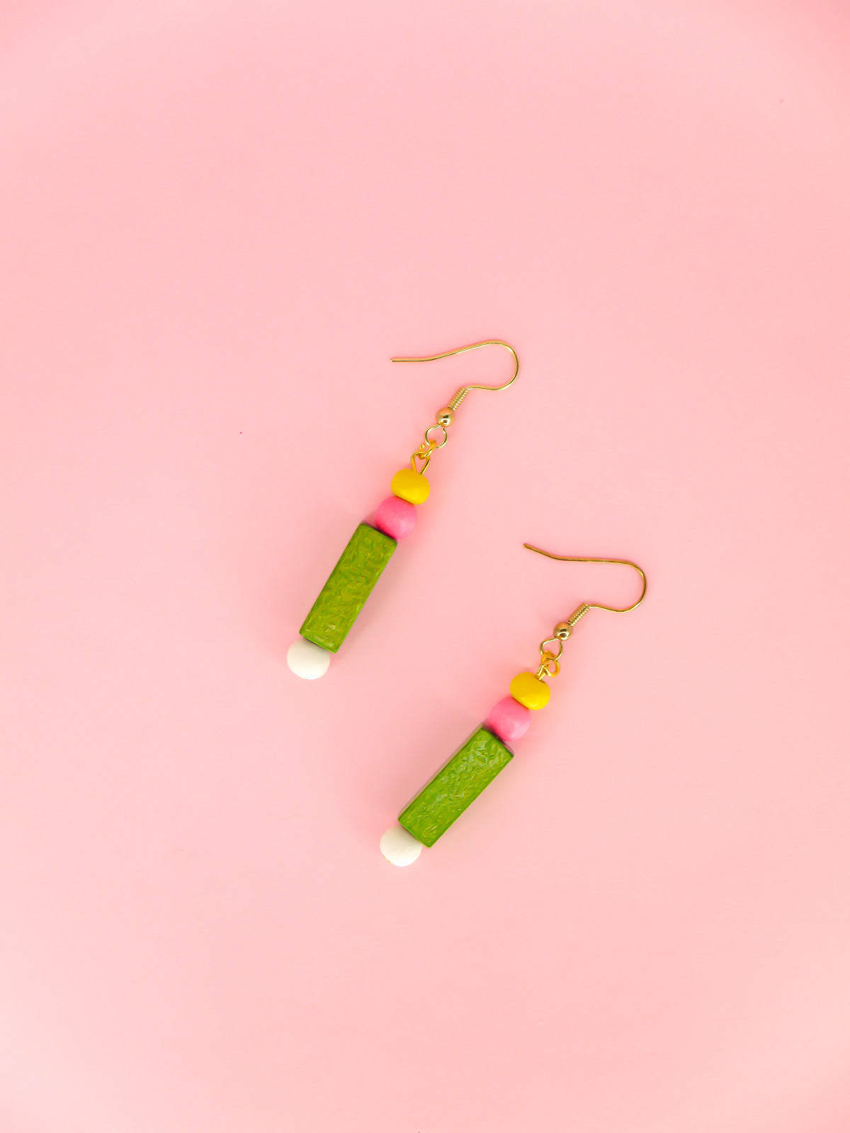 Colourful lightweight wooden bead dangle earrings comprising yellow, pink, green & white beads in various shapes and sizes, hung from gold plated ear wires