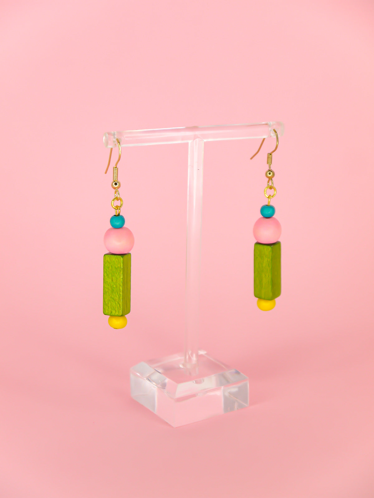 Colourful lightweight dangle earrings in various shaped wooden beads in blue, pink, green & yellow, hung from gold plated ear wires