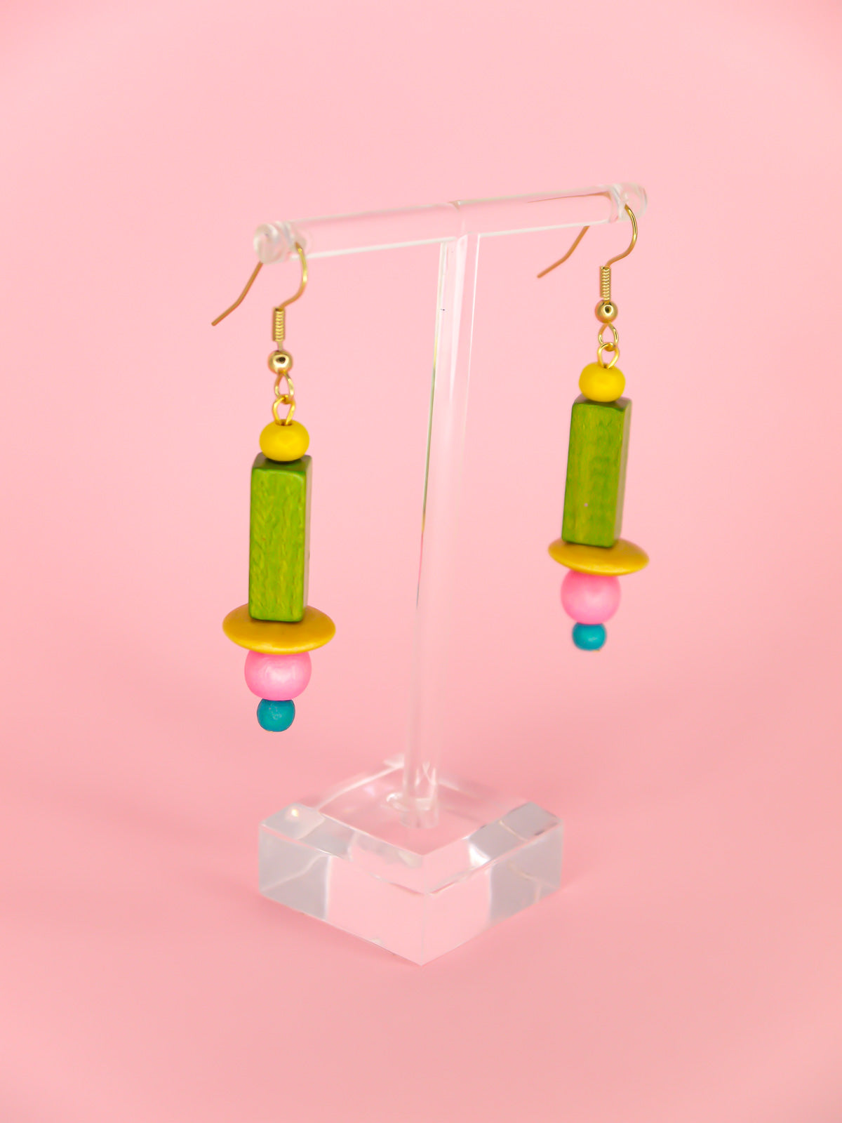 Colourful lightweight wooden bead earrings in various shaped beads in yellow, green, pink & blue, hung from gold plated ear wires