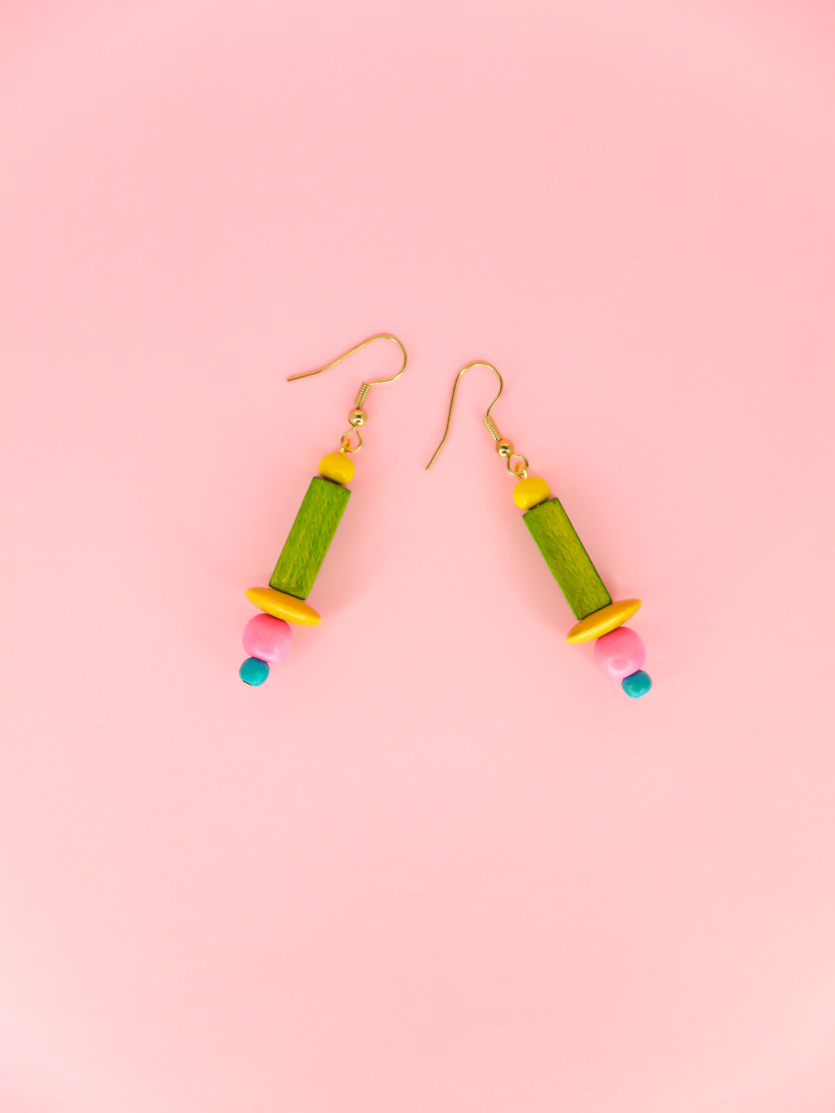 Colourful lightweight wooden bead earrings in various shaped beads in yellow, green, pink & blue, hung from gold plated ear wires