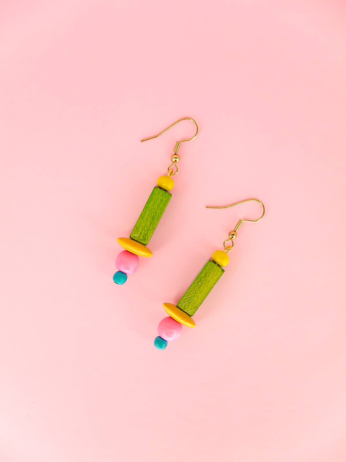 Colourful lightweight wooden bead earrings in various shaped beads in yellow, green, pink & blue, hung from gold plated ear wires