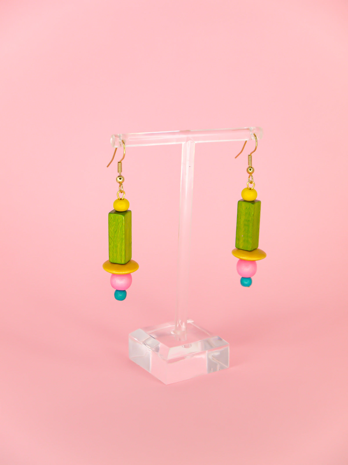 Colourful lightweight wooden bead earrings in various shaped beads in yellow, green, pink & blue, hung from gold plated ear wires