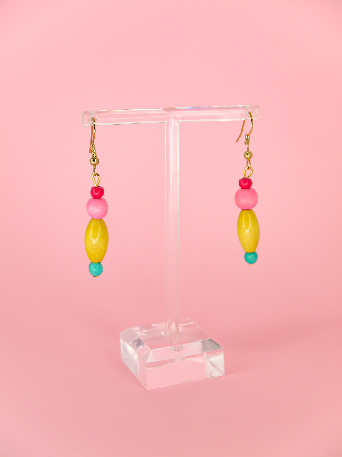 Colourful lightweight wooden bead earrings in various shapes in pink, yellow & blue beads, hung from gold plated ear wires