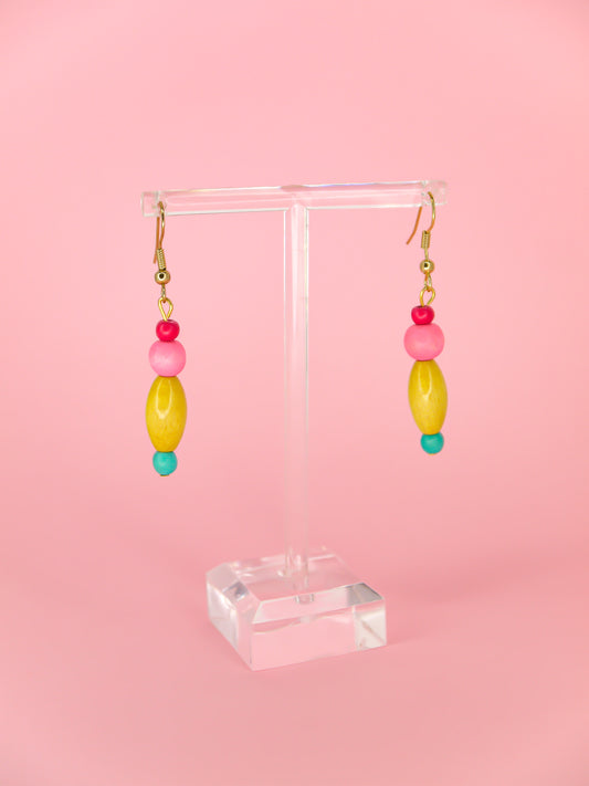 Colourful lightweight wooden bead earrings in various shapes in pink, yellow & blue beads, hung from gold plated ear wires