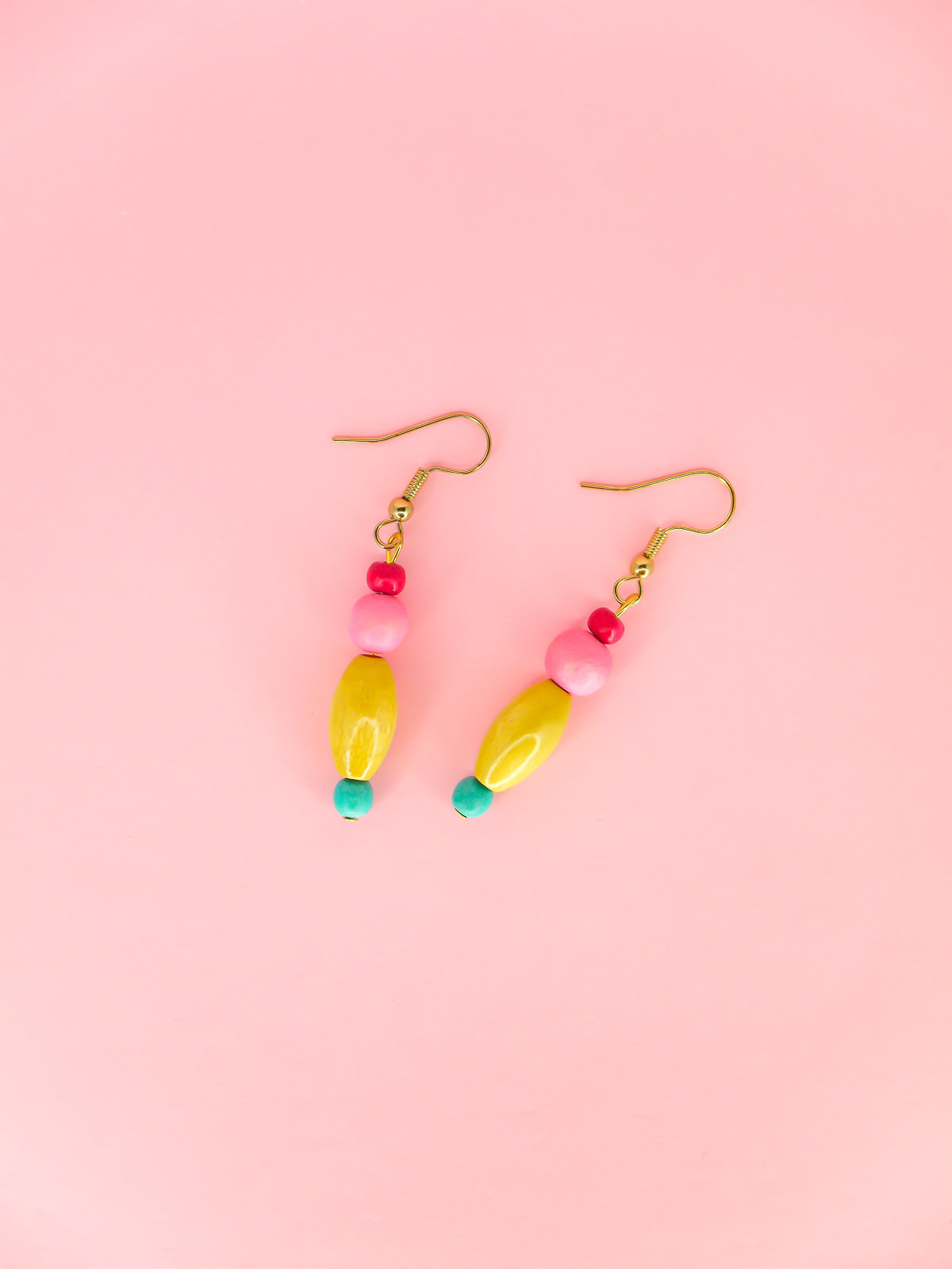 Colourful lightweight wooden bead earrings in various shapes in pink, yellow & blue beads, hung from gold plated ear wires