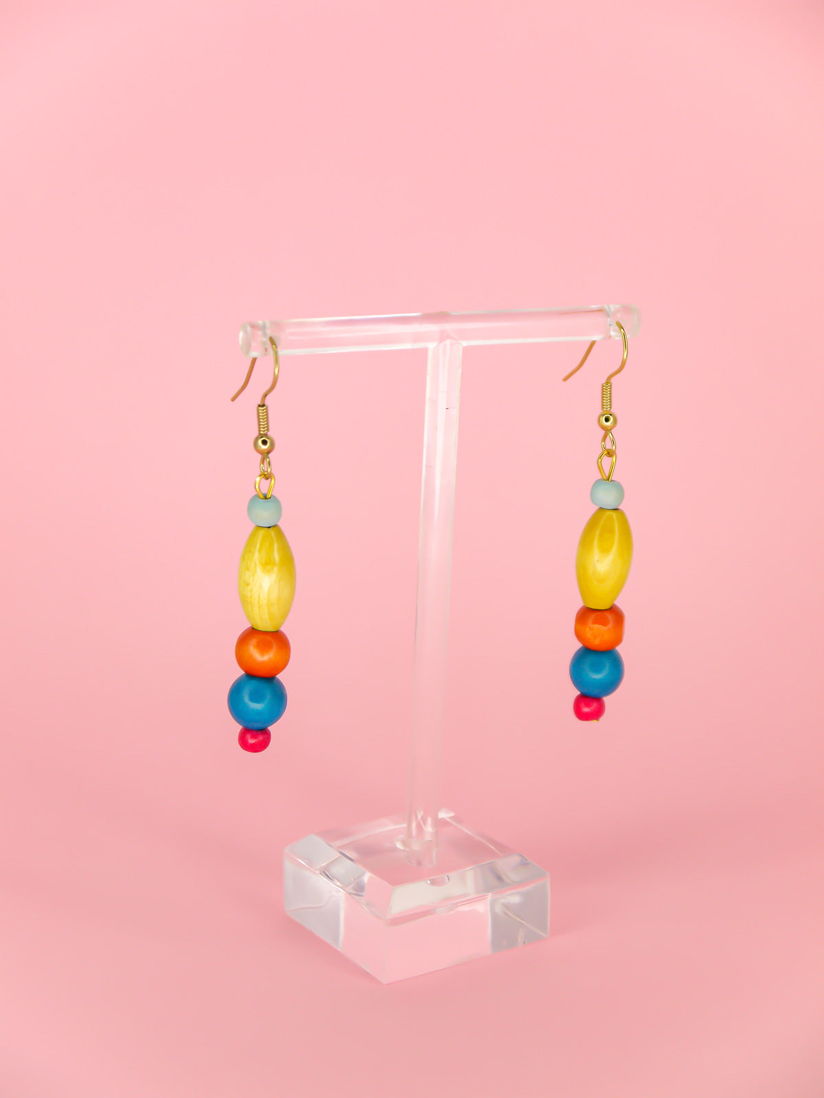 Colourful lightweight wooden bead dangle earrings in various shaped beads in blue, yellow, orange & pink, hung from gold plated ear wires