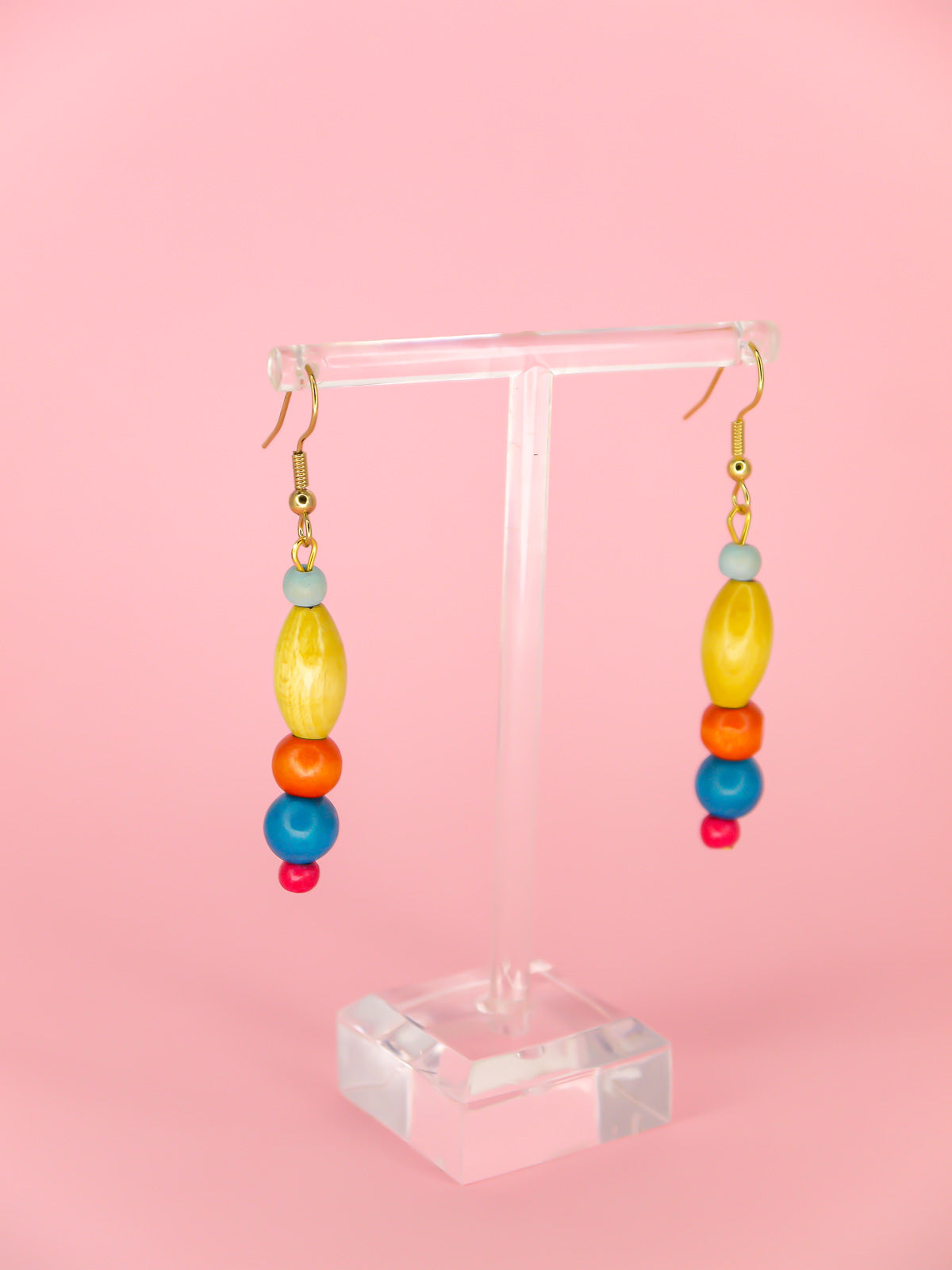 Colourful lightweight wooden bead dangle earrings in various shaped beads in blue, yellow, orange & pink, hung from gold plated ear wires