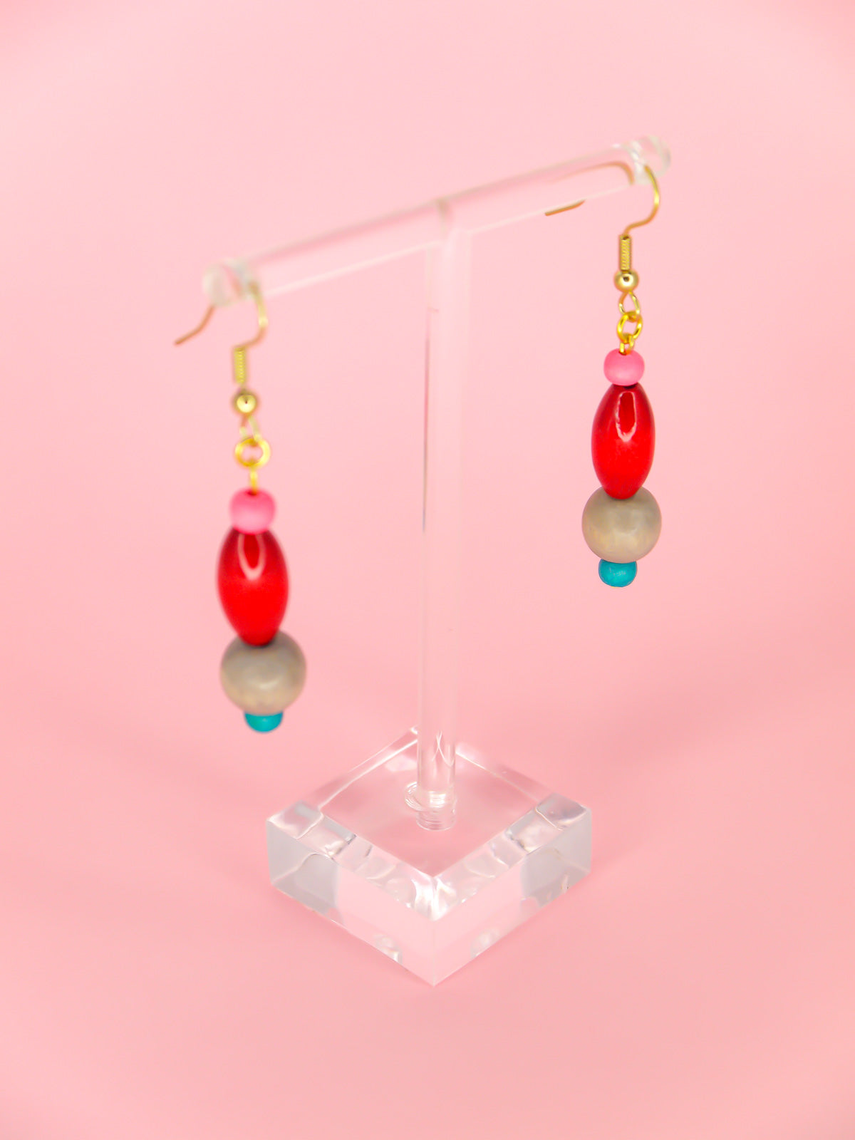 Colourful lightweight wooden bead dangle earrings in various shaped beads in pink, red, grey & blue, hung from gold plated ear wires