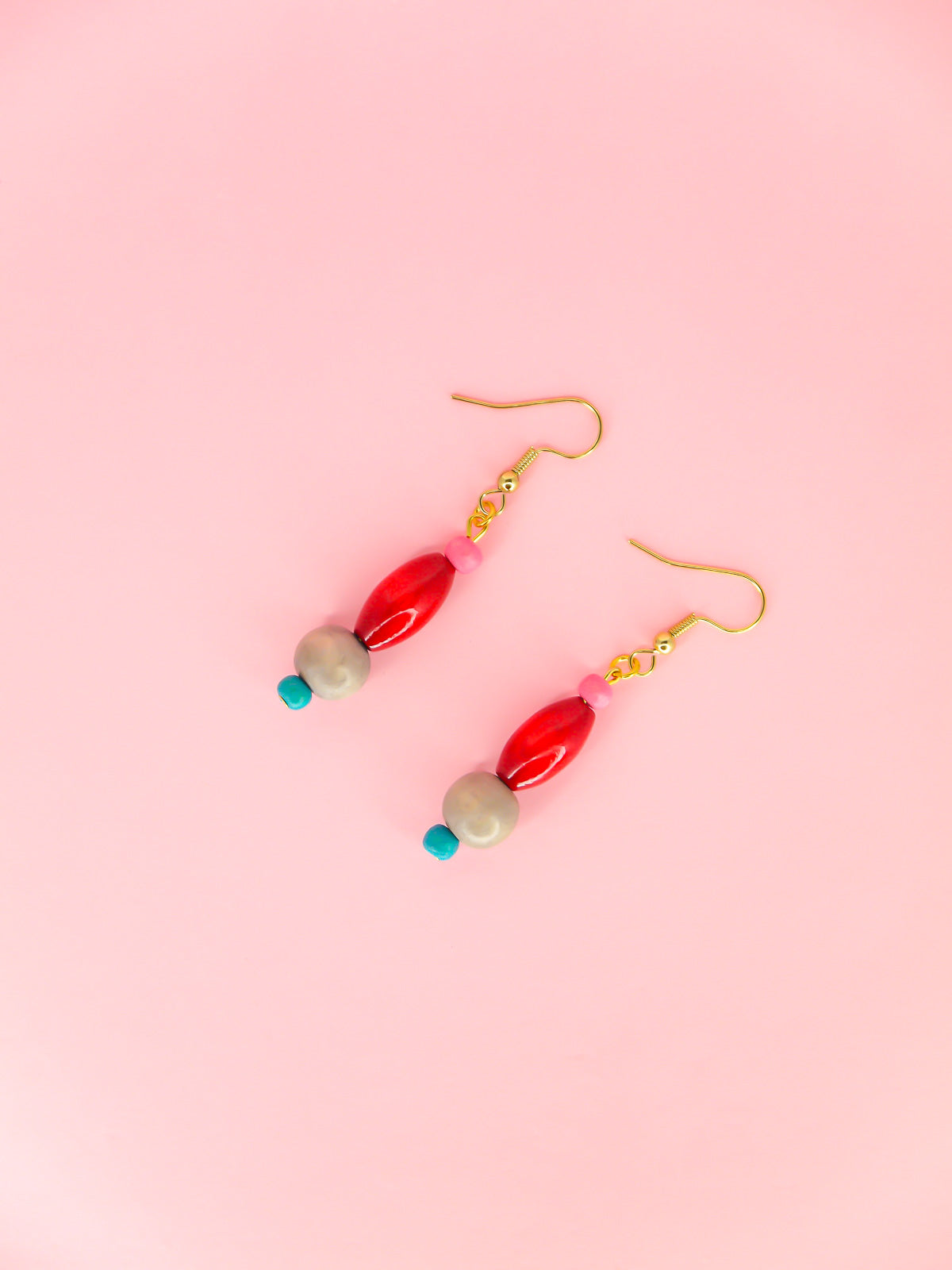 Colourful lightweight wooden bead dangle earrings in various shaped beads in pink, red, grey & blue, hung from gold plated ear wires