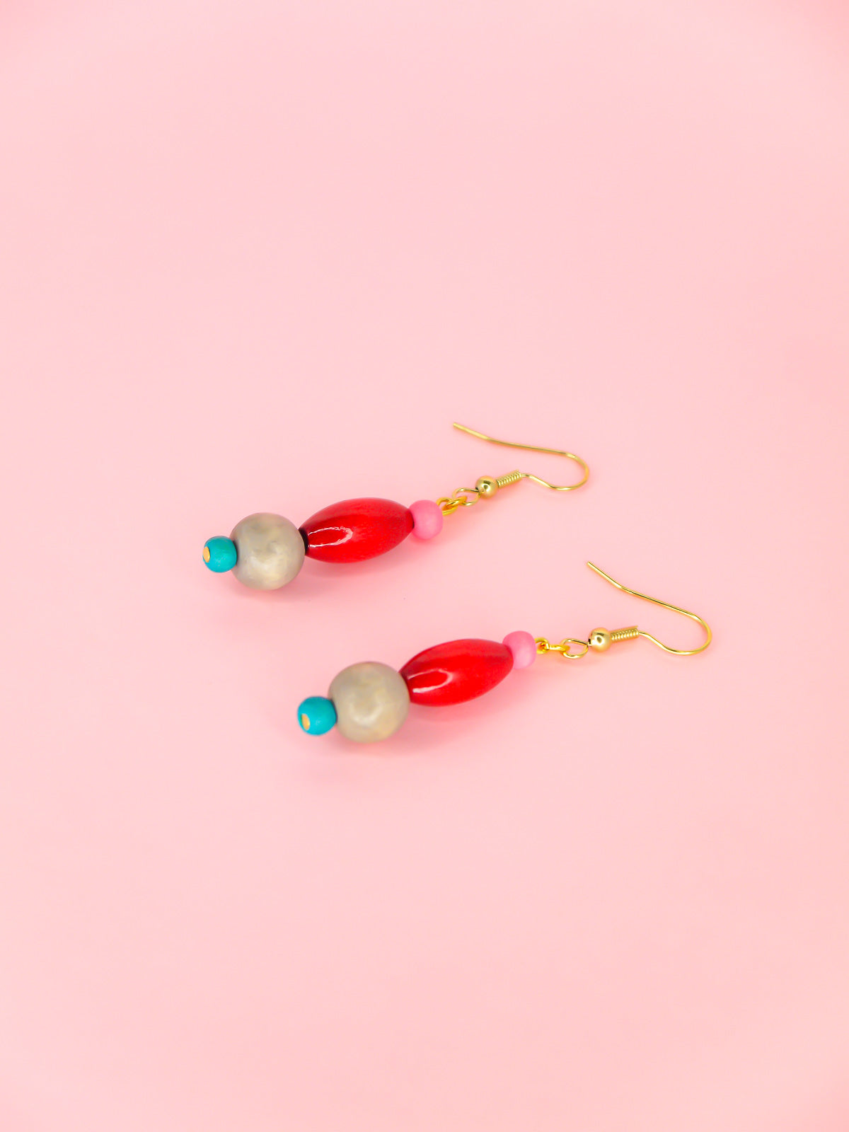 Colourful lightweight wooden bead dangle earrings in various shaped beads in pink, red, grey & blue, hung from gold plated ear wires