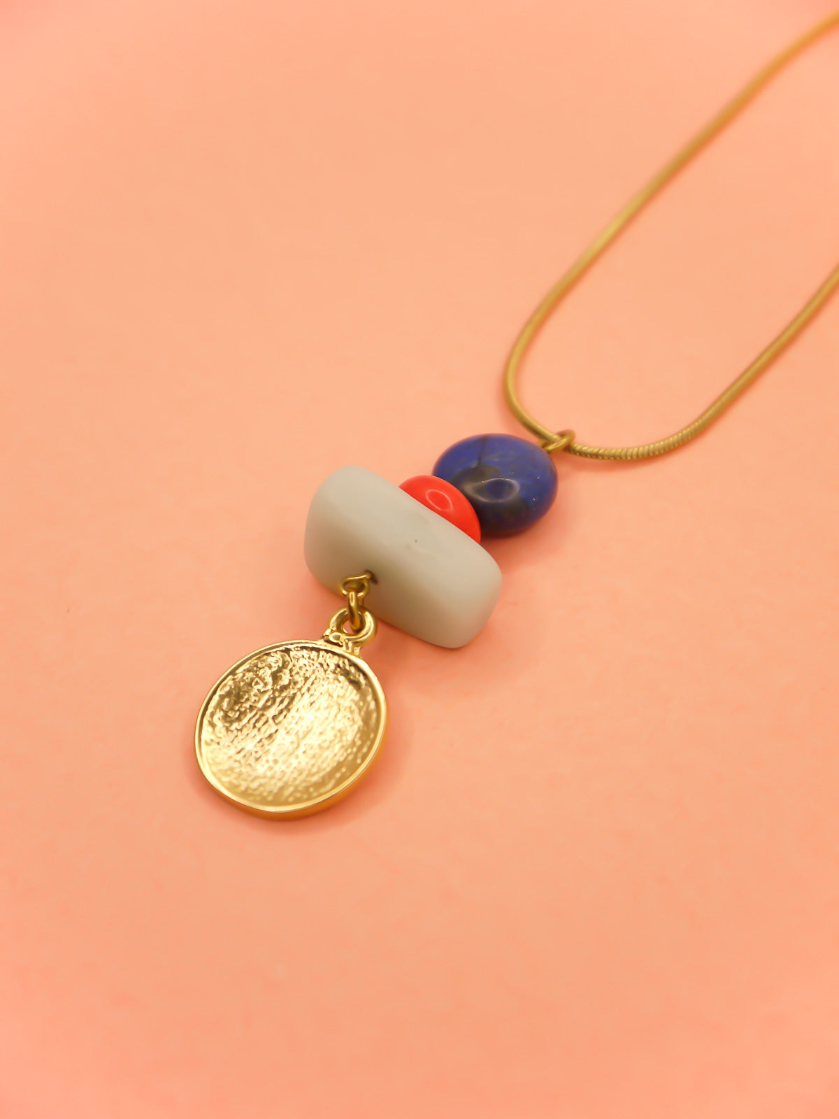 Crystal gemstone pendant necklace with lapis lazuli, coral and amazonite bead stack with a 24k shiny gold hammered disk medallion strung on a 24k gold plated snake chain