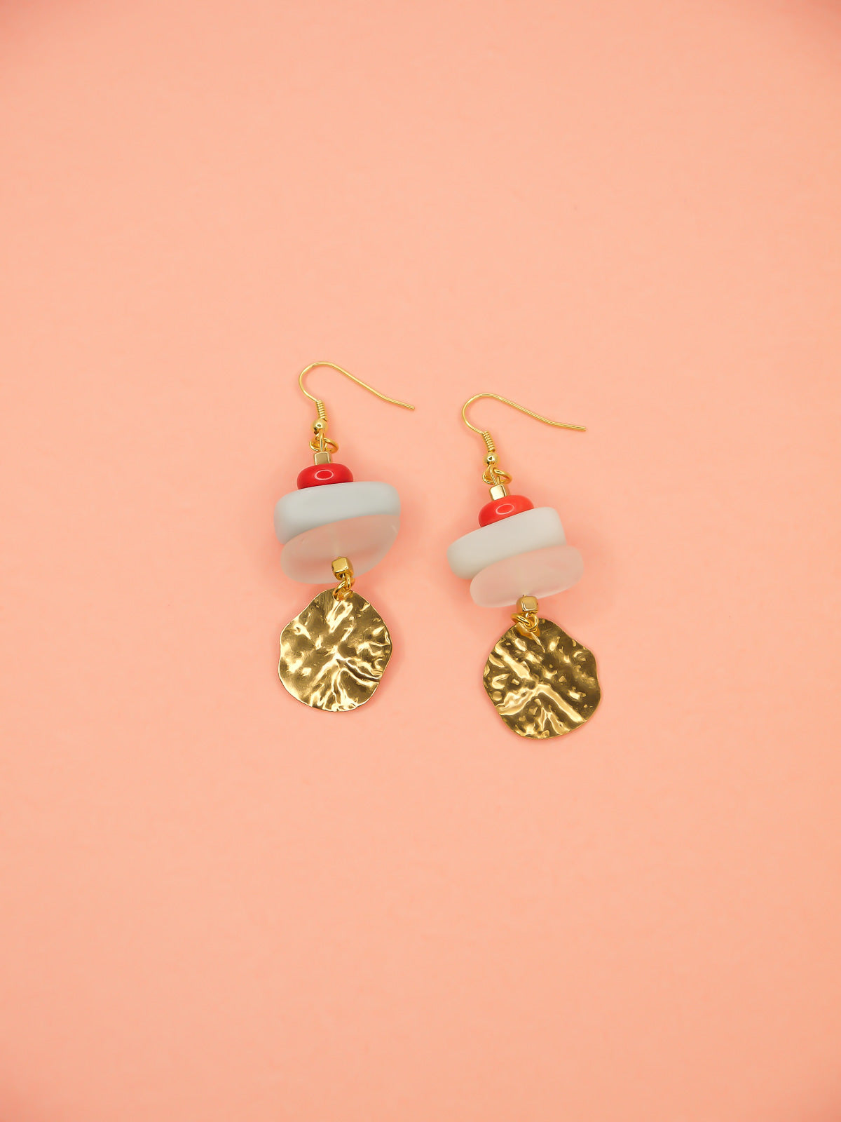 Gemstone crystal earrings with a stack of coral, amazonite and crystal quartz beads with a textured brass medallion charm, hung from gold plated ear wires