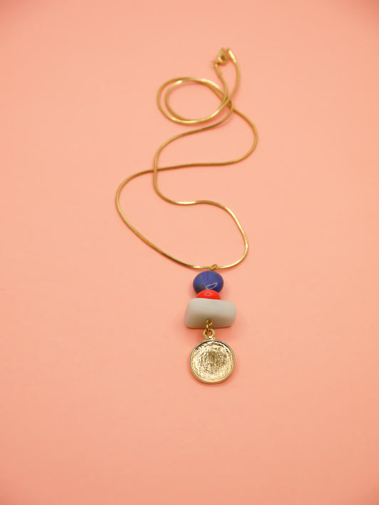 Crystal gemstone pendant necklace with lapis lazuli, coral and amazonite bead stack with a 24k shiny gold hammered disk medallion strung on a 24k gold plated snake chain