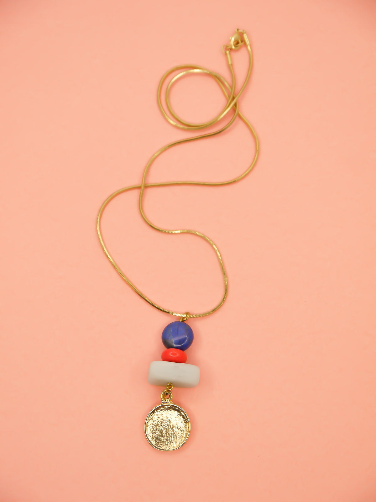 Crystal gemstone pendant necklace with lapis lazuli, coral and amazonite bead stack with a 24k shiny gold hammered disk medallion strung on a 24k gold plated snake chain