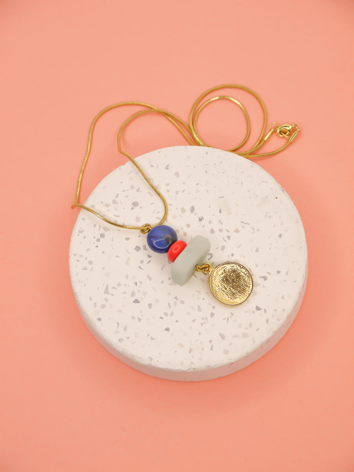 Crystal gemstone pendant necklace with lapis lazuli, coral and amazonite bead stack with a 24k shiny gold hammered disk medallion strung on a 24k gold plated snake chain