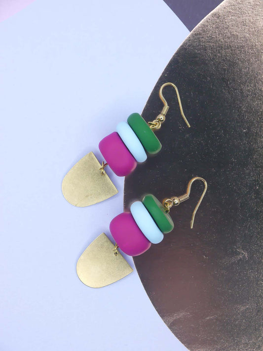 Colourful beaded earrings on a gold foil background