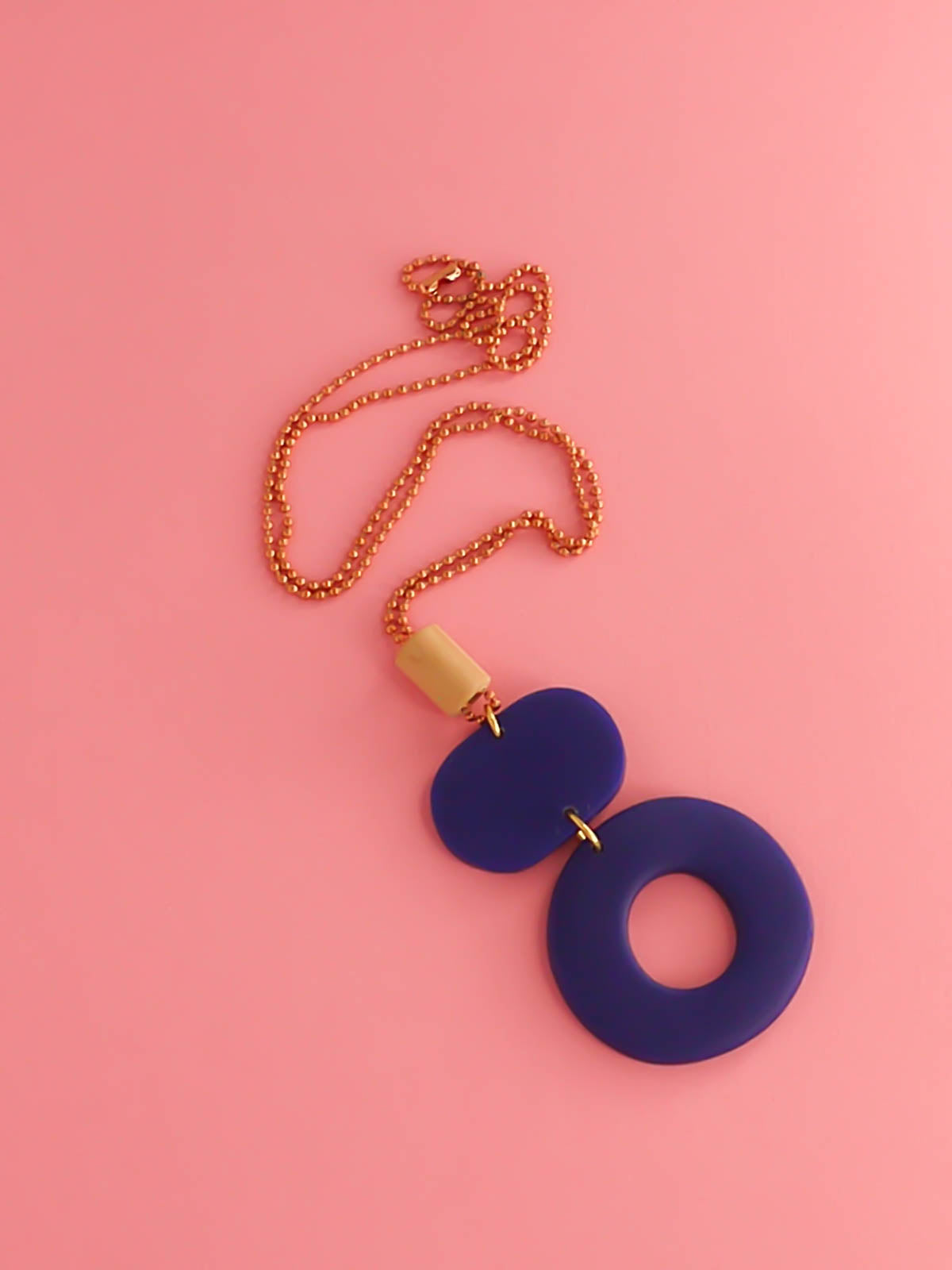 Geometric polymer clay pendant necklace with cobalt blue hoop circle, rectangle & a wooden tube bead strung on a copper ball chain