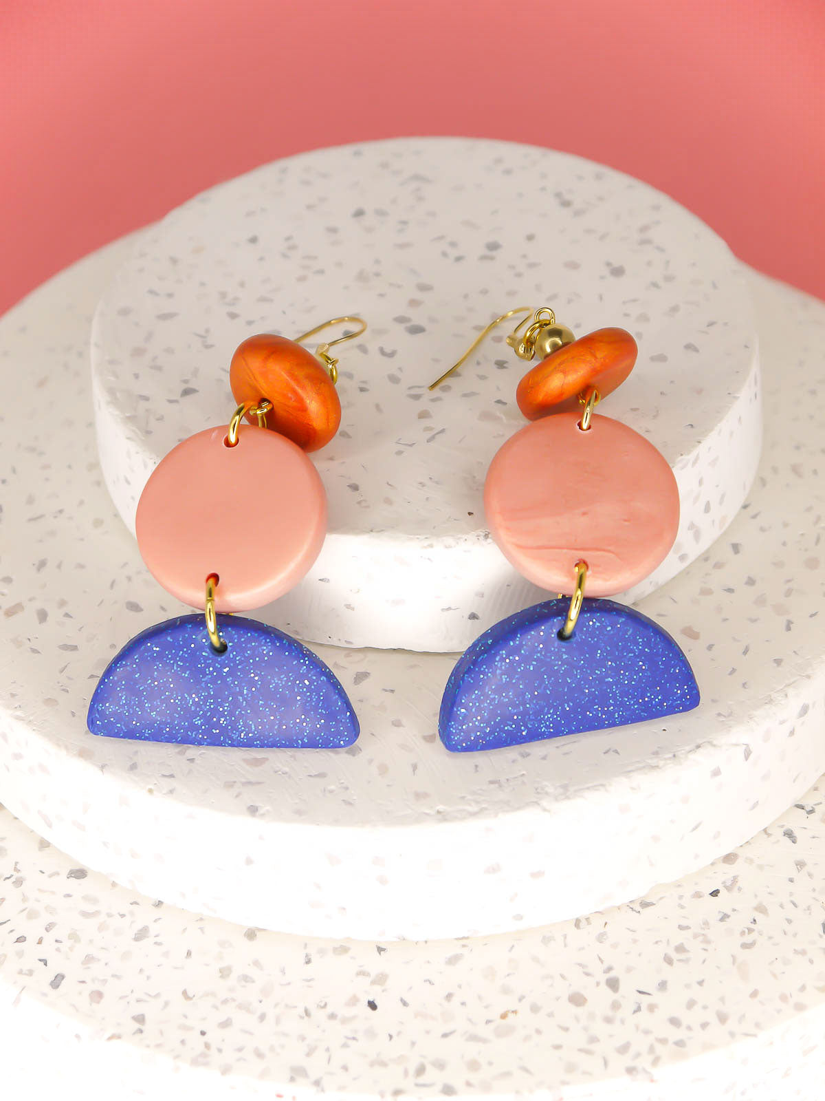 Geometric 3 tier dangle statement earrings with a blue glitter semi circle, rose gold circle & a rust bead, topped with a brass ball bead and gold plated ear wires