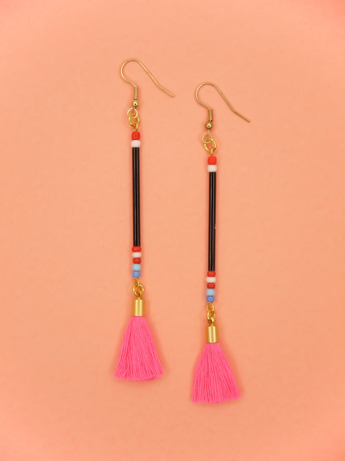 Long delicate bead tassel dangle earrings with black glass beads & multicoloured seed beads with a hot pink cotton tassel hung from gold plated nickel free ear wires