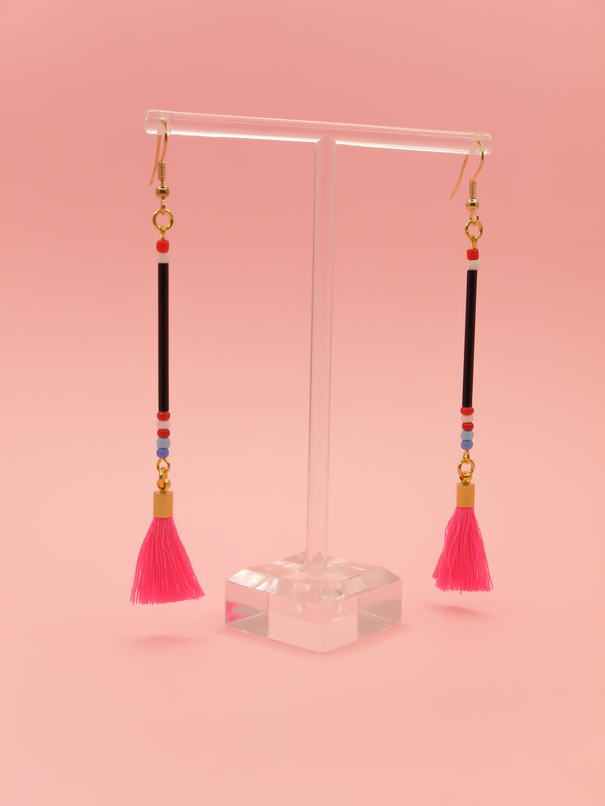 Long delicate bead tassel dangle earrings with black glass beads & multicoloured seed beads with a hot pink cotton tassel hung from gold plated nickel free ear wires