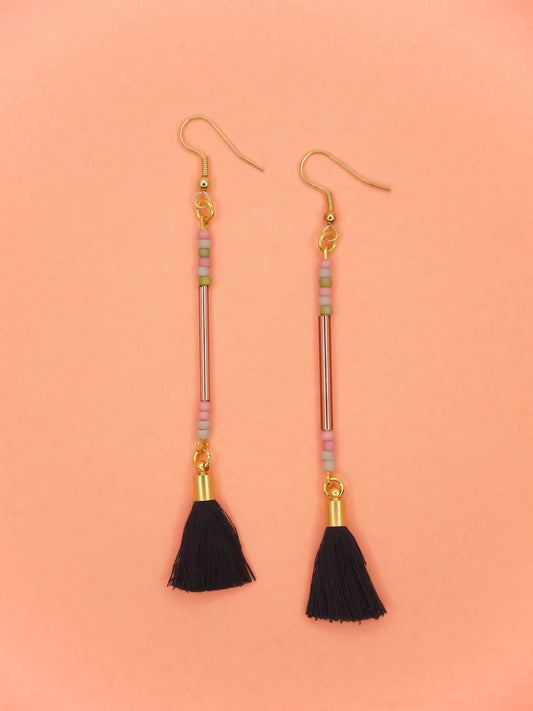 Long delicate bead stick dangle earrings with a lilac glass tube bead & seed beads in green, pink & grey, paired with a navy tassel and hung from gold plated nickel free ear wires