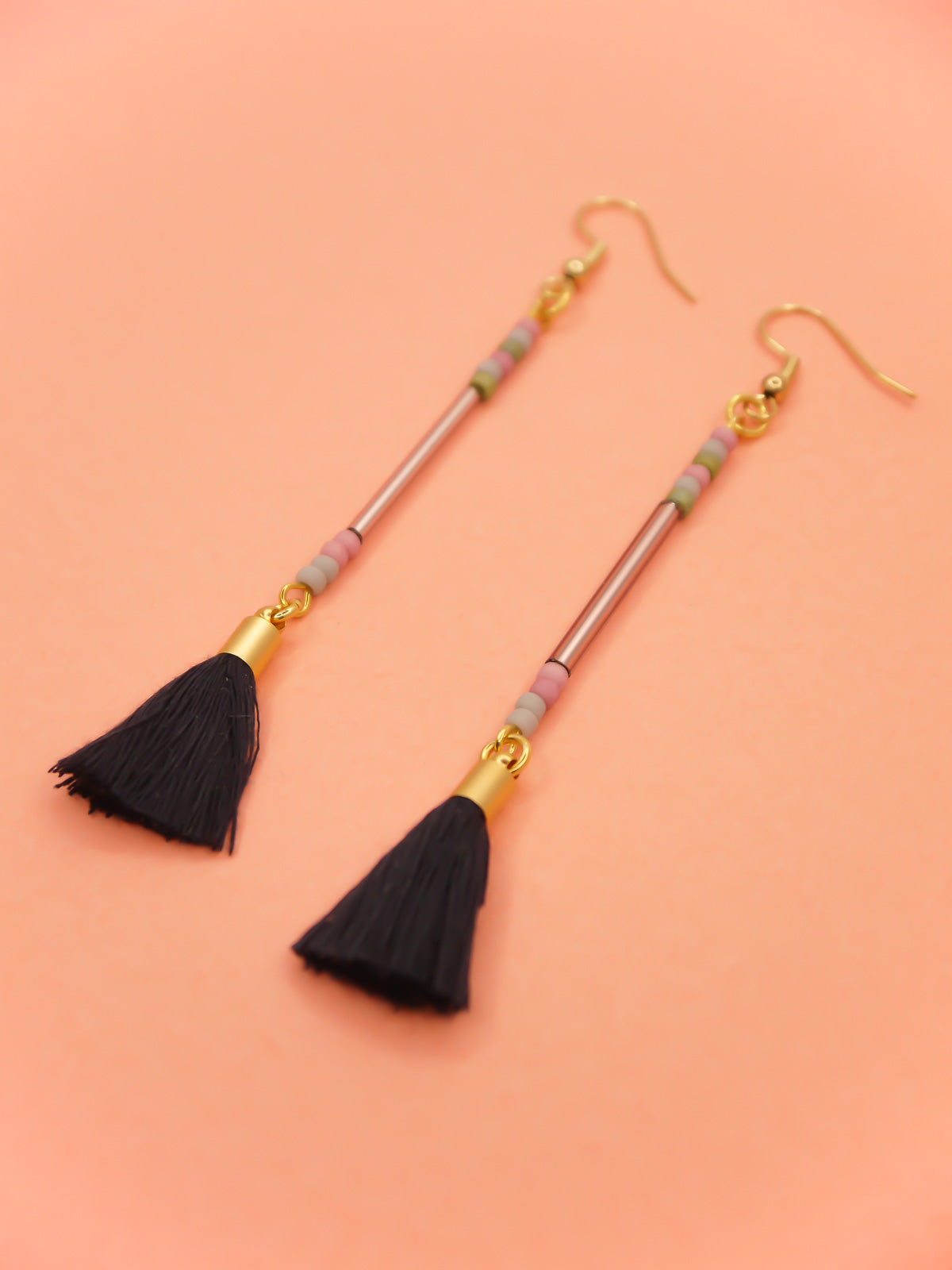 Long delicate bead stick dangle earrings with a lilac glass tube bead & seed beads in green, pink & grey, paired with a navy tassel and hung from gold plated nickel free ear wires