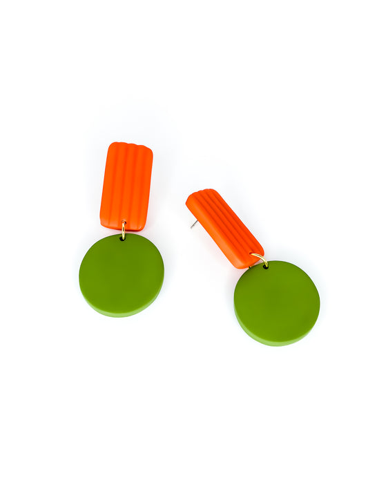 Pair of geometric earrings with green round pendants and orange rectangular striped tops on a white background