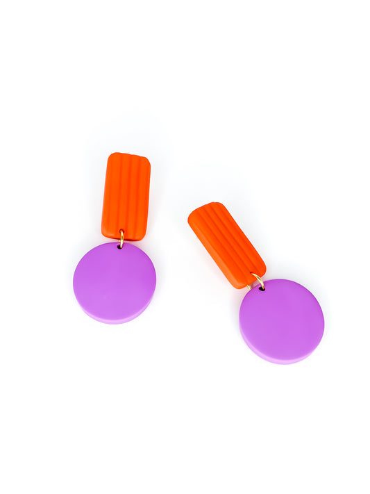 Pair of geometric earrings with striped orange rectangles and purple circles on a white background