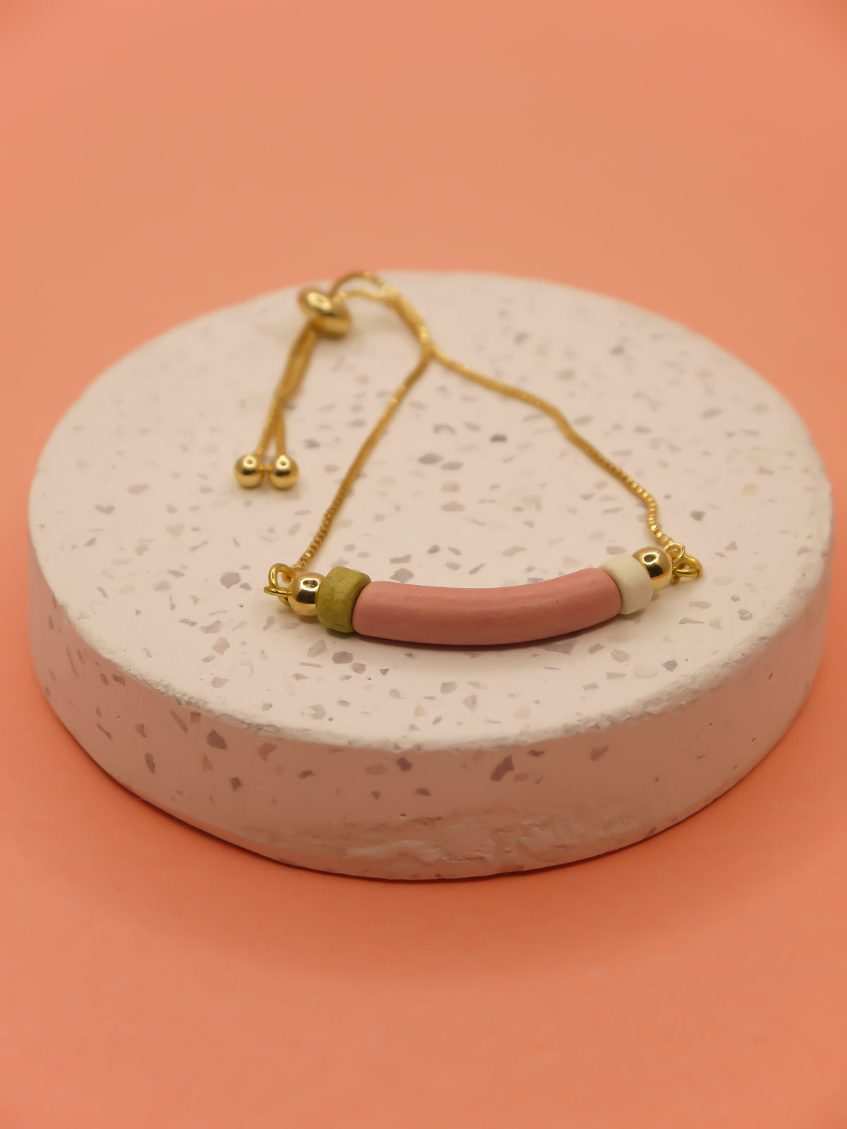 Pink curved ceramic bead gold chain bracelet