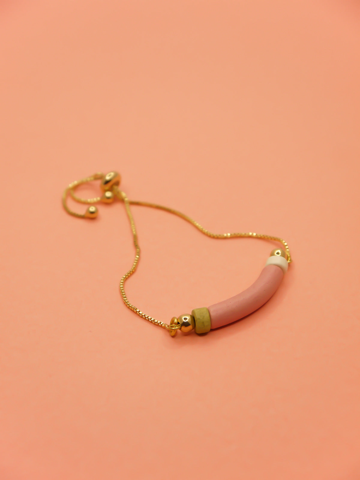 Pink curved ceramic bead gold chain bracelet