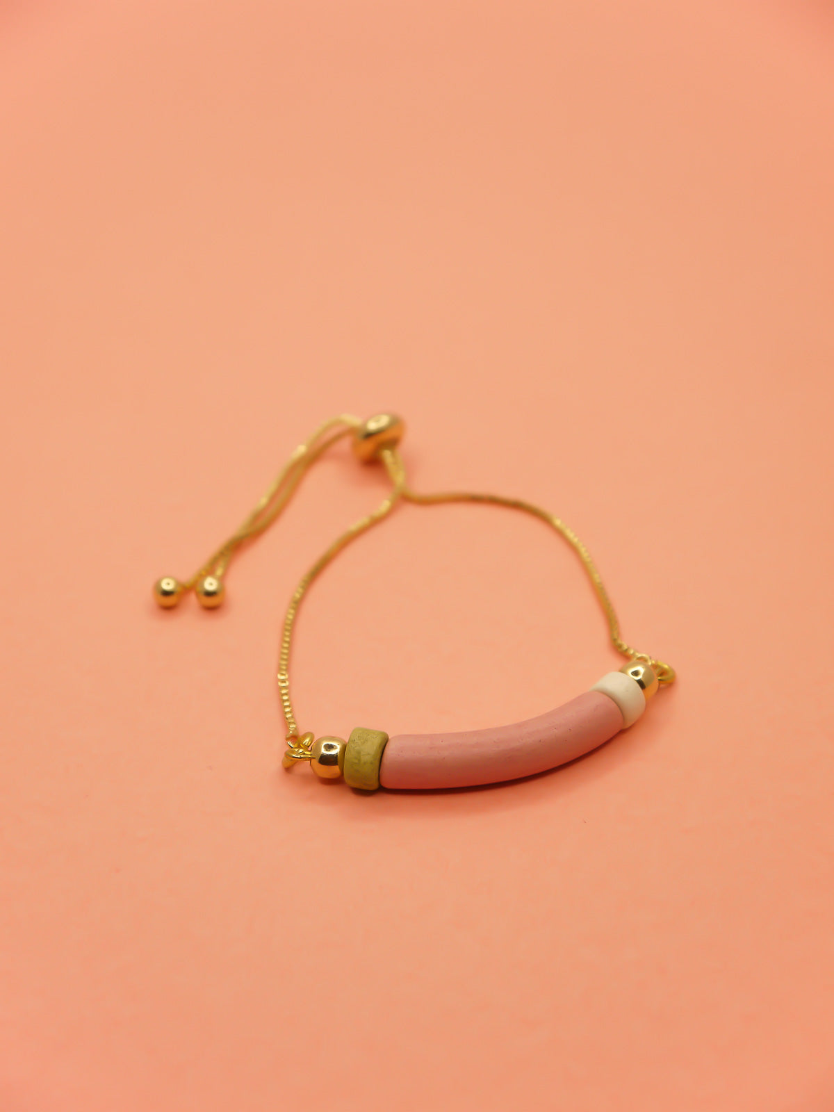 Pink curved ceramic bead gold chain bracelet