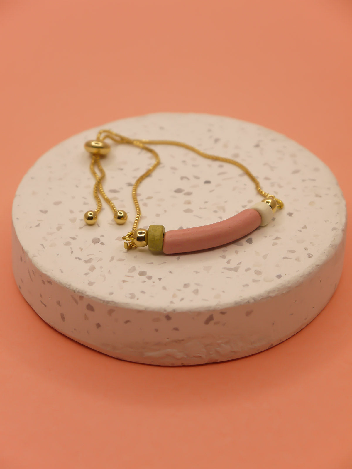 Pink curved ceramic bead gold chain bracelet