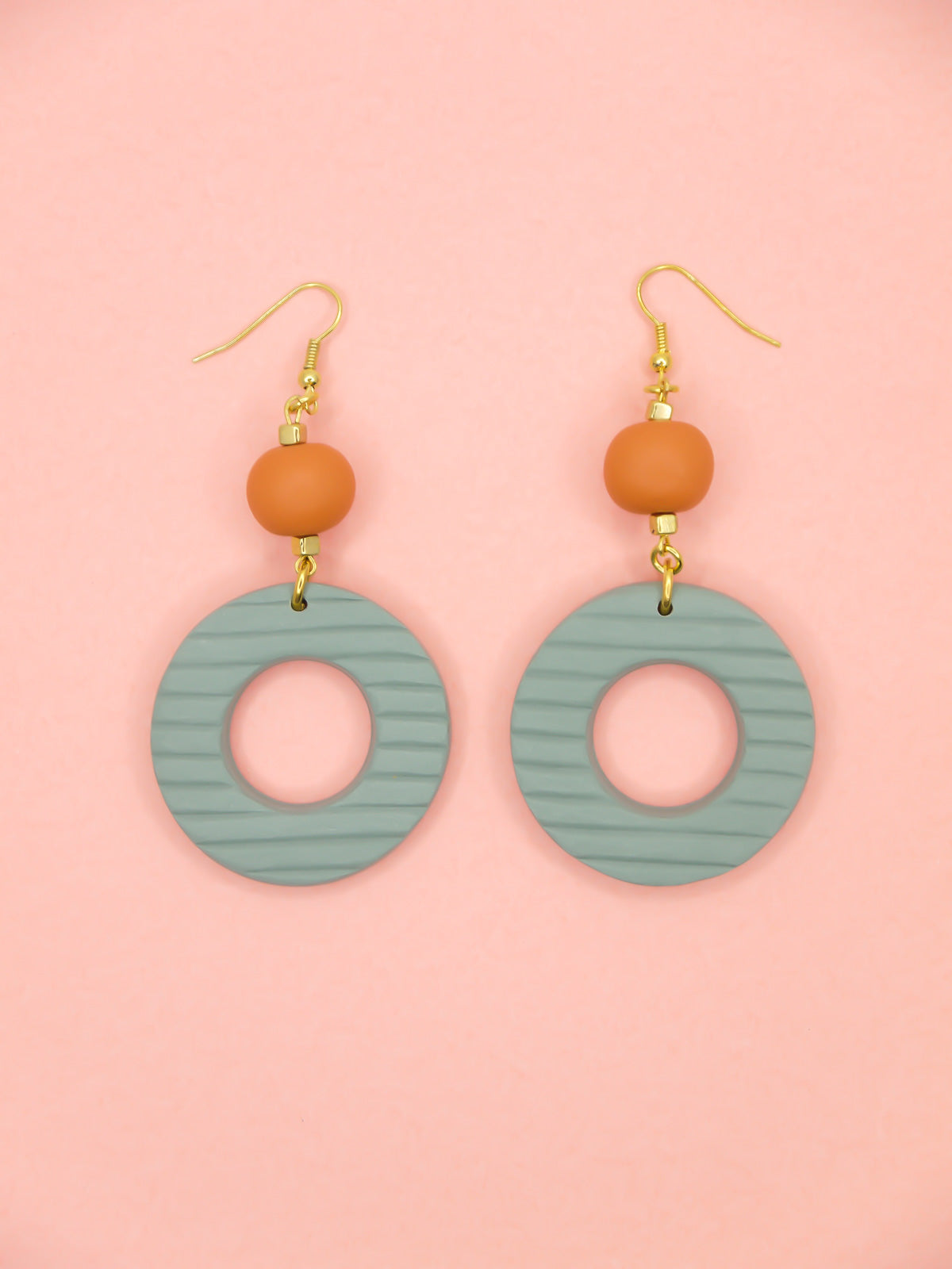 Geometric polymer clay statement dangle earrings with sage striped textured hoops, connected to terracotta ball beads and hung from brass ear wires.