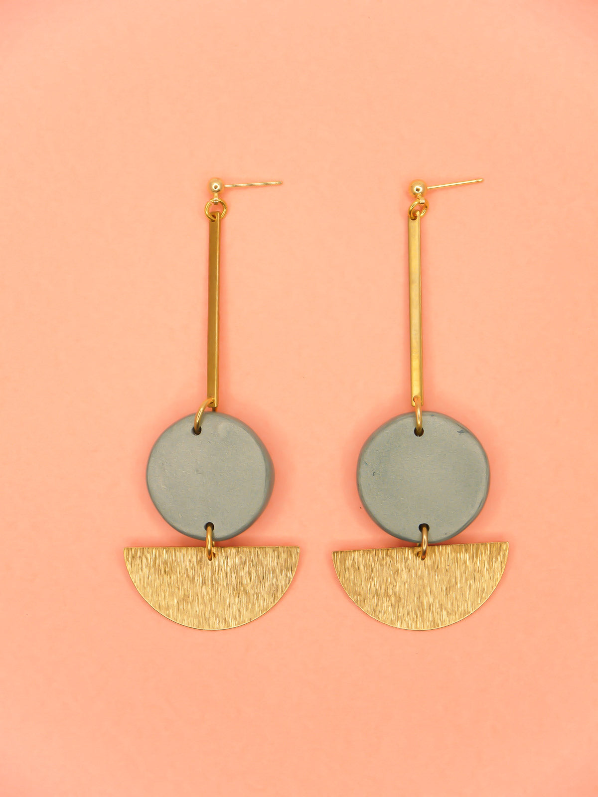 Dangle geometric statement earrings with a gold plated ball stud, a brass stick with a polymer clay round metallic circle in turquoise connected to a textured brass semi circle