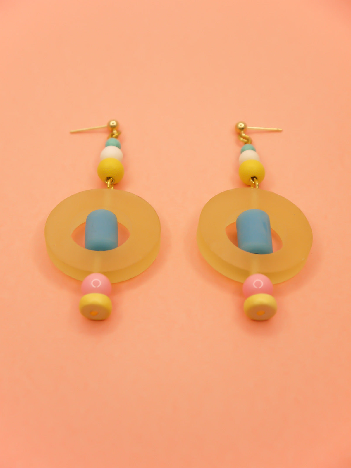 Colourful lightweight hoop bead earrings with glass & wood beads in yellow, pink & turquoise with a resin yellow hoop in the centre & a resin blue tube bead in the middle. Hung from 24k gold plated ball studs.