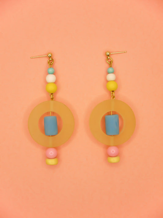 Colourful lightweight hoop bead earrings with glass & wood beads in yellow, pink & turquoise with a resin yellow hoop in the centre & a resin blue tube bead in the middle. Hung from 24k gold plated ball studs.