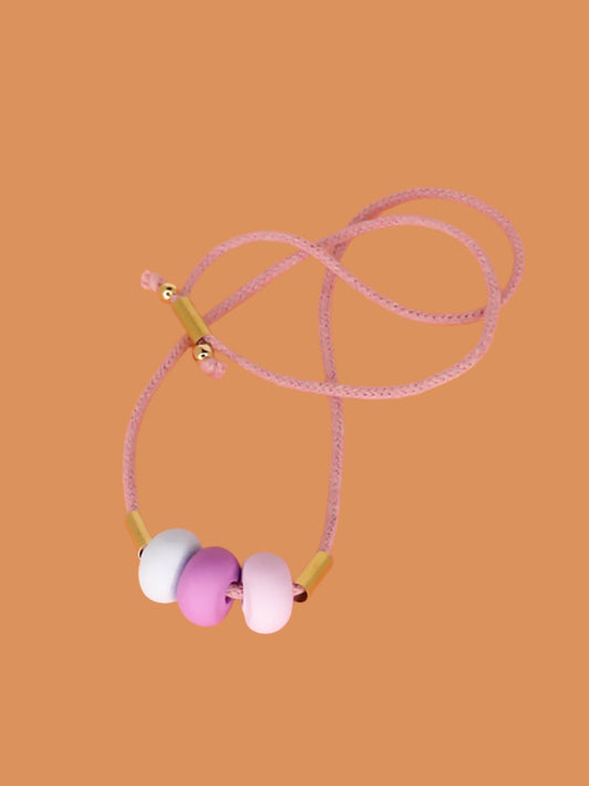 Lightweight statement bead necklace made up of lilac cotton rope which is adjustable so wear it long or short. 3 handmade polymer clay beads in lilac, purple and ice blue with 2 brass tube beads.